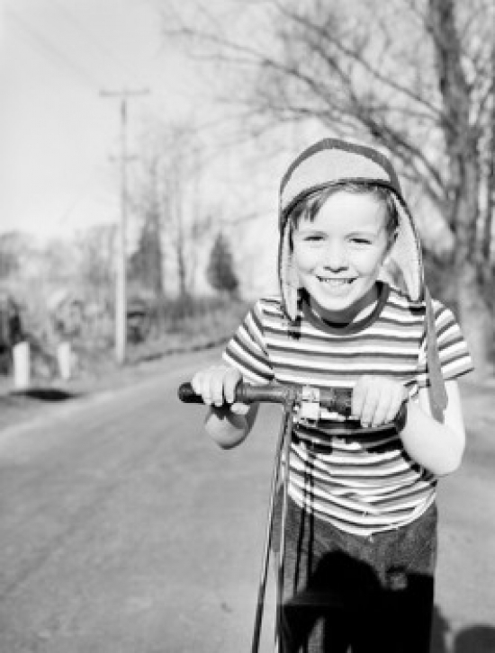 Boy Riding Push Scooter Poster Print - 18 x 24 in.
