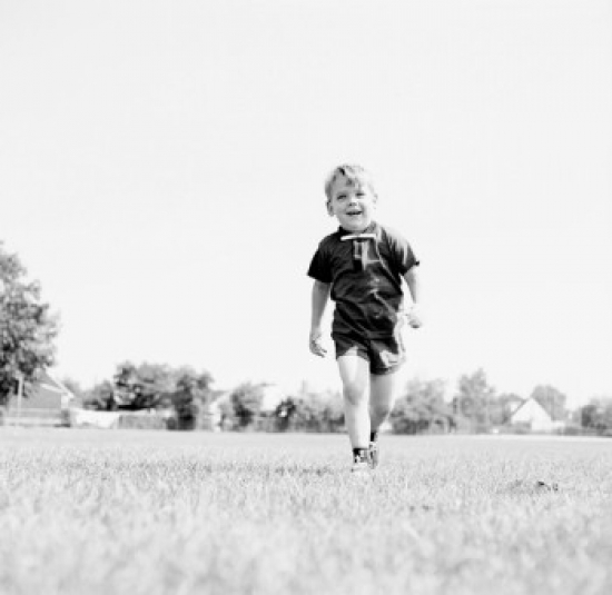 Little Boy Walking on Field Poster Print - 18 x 24 in.