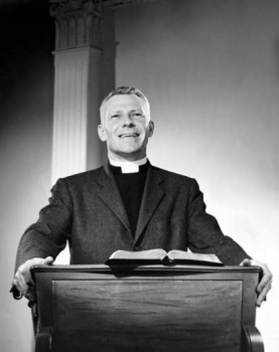 Priest Standing at a Lectern & Preaching Poster Print - 18 x 24 in.