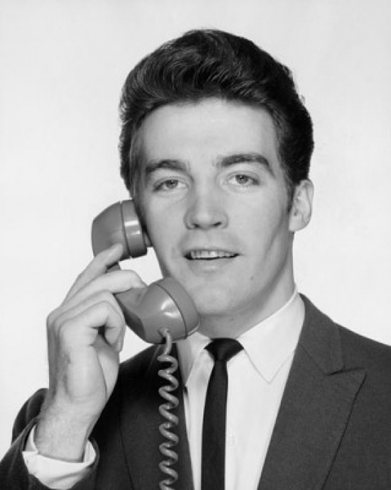 Young Businessman Using Telephone Poster Print - 18 x 24 in.