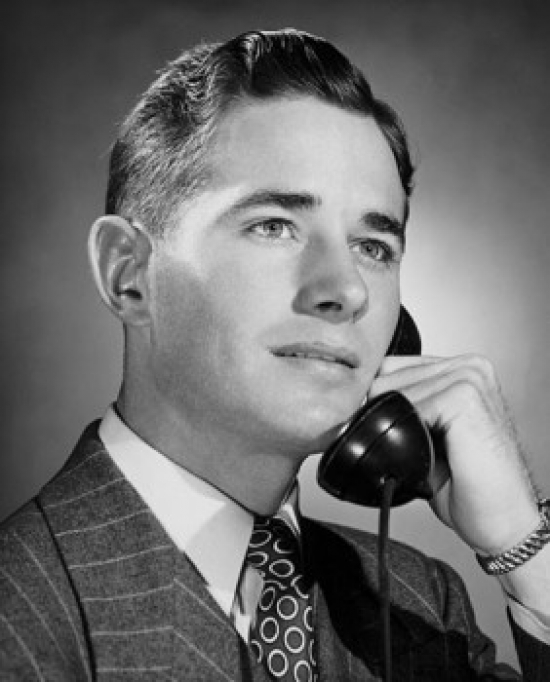 Young Businessman Using Telephone Poster Print - 18 x 24 in.