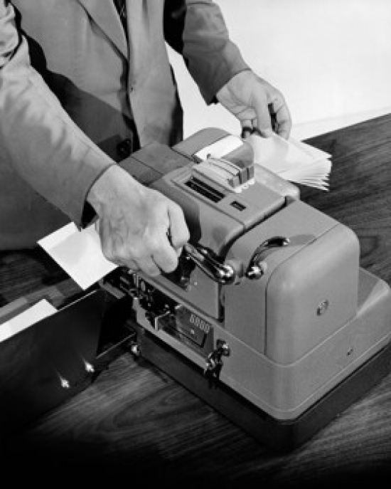 High Angle View of a Businessman Using a Lamination Machine Poster Print - 18 x 24 in.