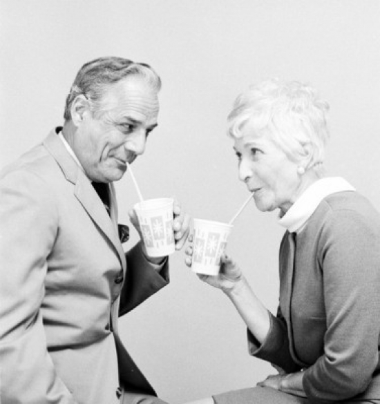 Senior Couple Drinking & Looking Each Other Poster Print - 18 x 24 in.