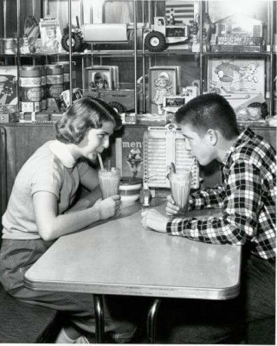 SAL2555476 Side Profile of a Young Couple Drinking a Milkshake in a Restaurant 1954 Poster Print - 18 x 24 in.