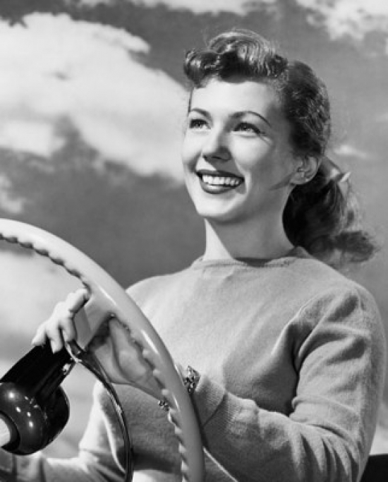 SAL2557895A Close-Up of a Young Woman Holding the Steering Wheel of a Car & Smiling Poster Print - 18 x 24 in.