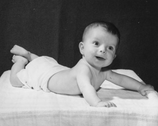 Baby Lying on a Blanket & Smiling Poster Print - 18 x 24 in.