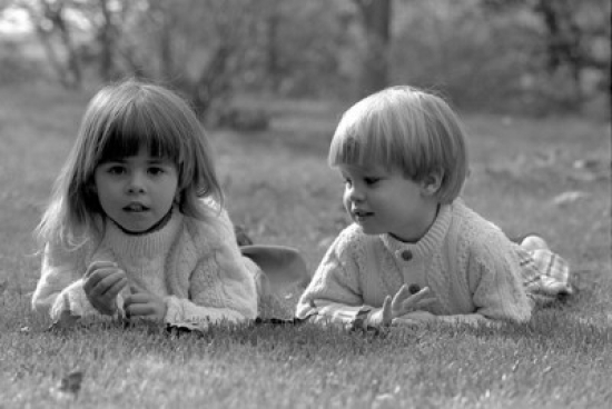 Boy & Girl Lying on Grass Poster Print - 18 x 24 in.