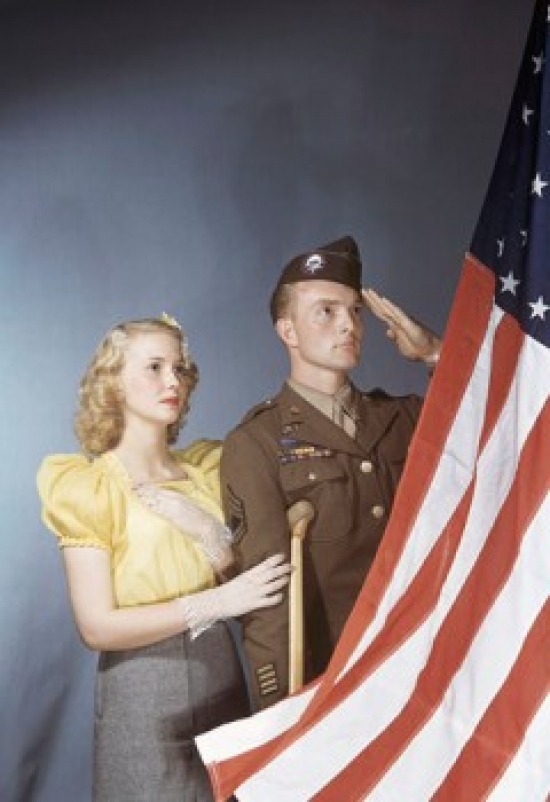 SAL38074987 Young Man Saluting an American Flag with a Young Woman Standing Beside Him Poster Print - 18 x 24 in.