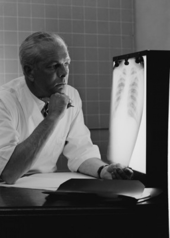 Doctor Examining X-Ray Poster Print - 18 x 24 in.