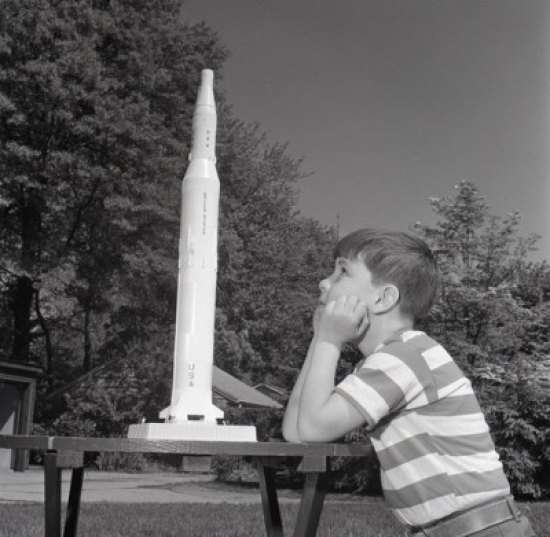 Boy Playing with Toy Rocket Poster Print - 18 x 24 in.