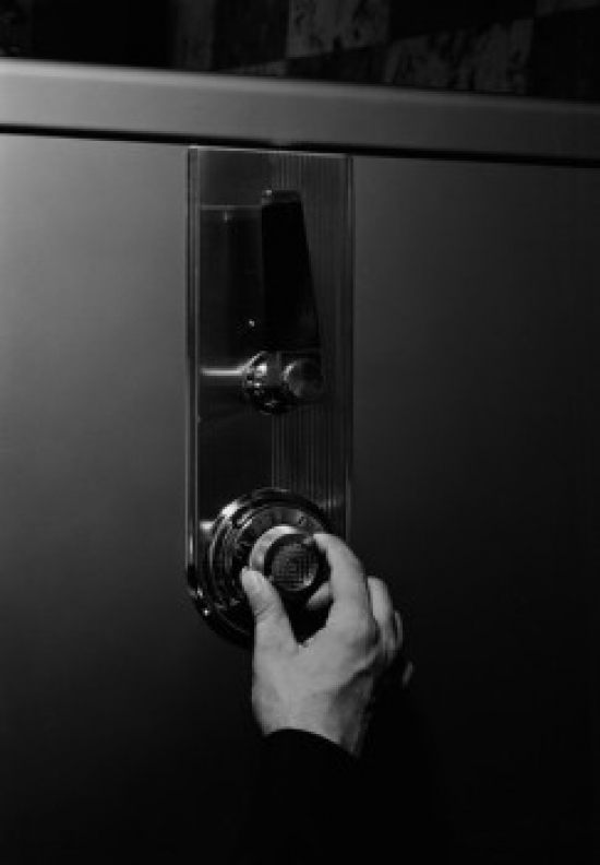 Hand Unlocking Safe Poster Print - 18 x 24 in.