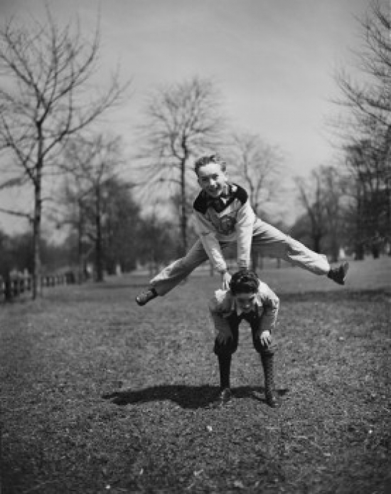 Two Boys Leapfrogging in Park Poster Print - 18 x 24 in.