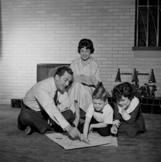 Parents with Kids Looking at Map Poster Print - 18 x 24 in.