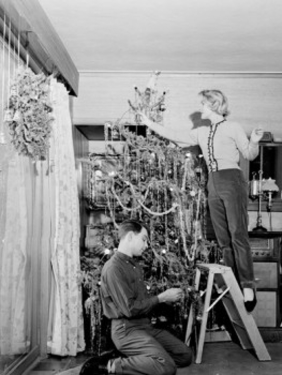 Couple Decorating Christmas Tree at Home Poster Print - 18 x 24 in.