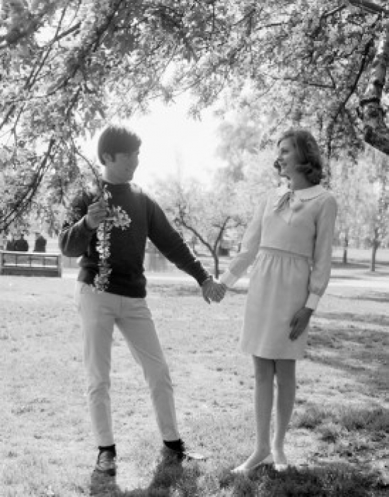 Young Couple Standing Under Tree Holding Hands Poster Print - 18 x 24 in.