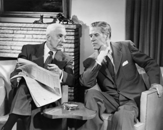 Two Businessmen Talking Indoors Poster Print - 18 x 24 in.
