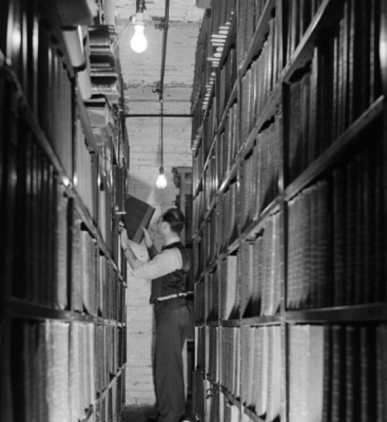 SAL25548076 Side Profile of a Businessman Pulling a File From a Shelf Poster Print - 18 x 24 in.
