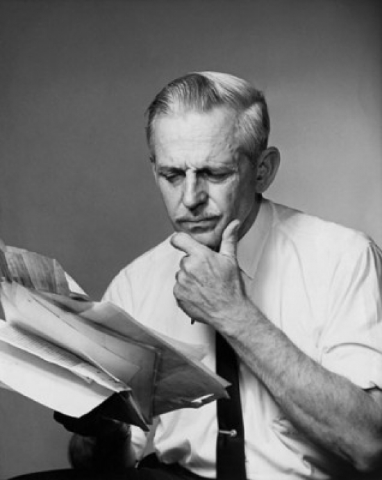 Senior Businessman Reading Documents Poster Print - 18 x 24 in.