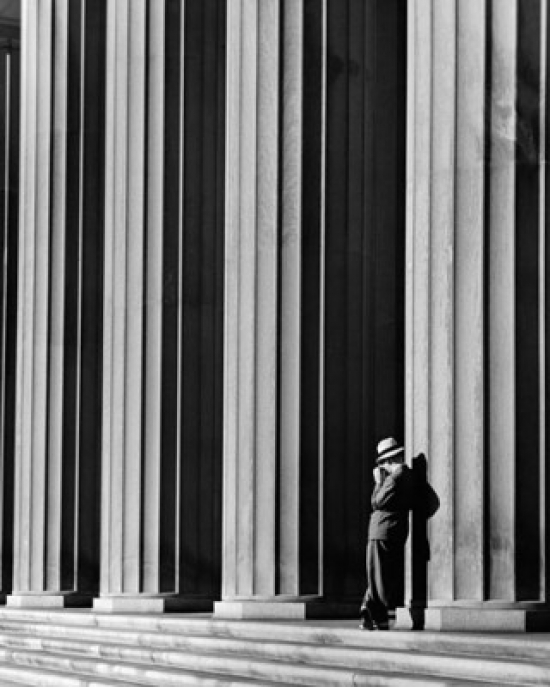Businessman Leaning Against a Column Poster Print - 18 x 24 in.