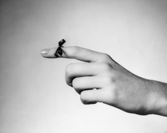 Close-Up of a String Tied on the Index Finger of a Woman Poster Print - 18 x 24 in.