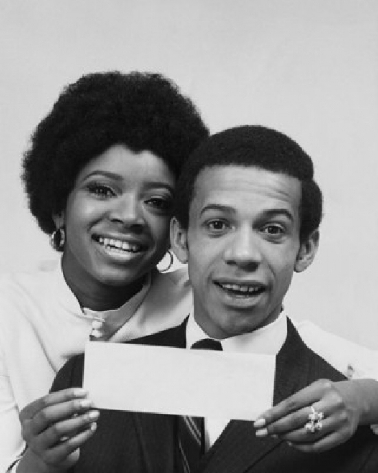 SAL2555324 Portrait of a Young Woman Smiling with a Young Man & Holding a Check Poster Print - 18 x 24 in.