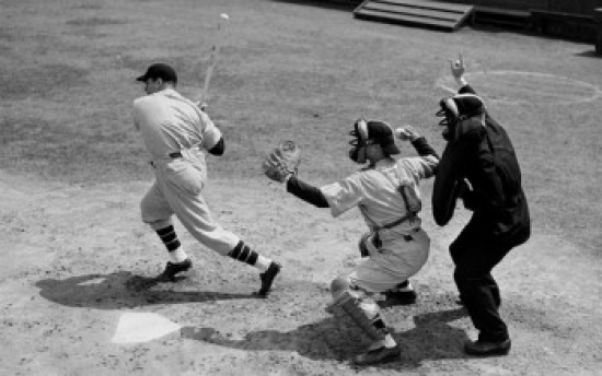 Baseball Player Swinging a Baseball Bat with a Baseball Catcher & a Baseball Umpire Standing Beside Him Poster Print - 18 x 24 in.