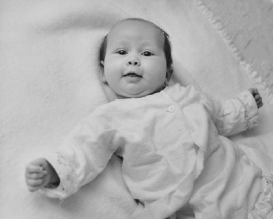 Baby Lying on a Blanket & Smiling Poster Print - 18 x 24 in.
