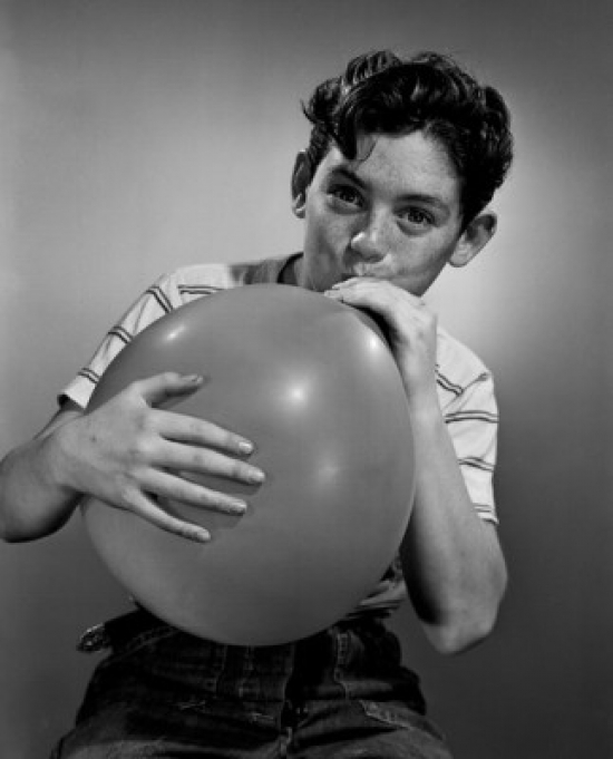 Boy Blowing Balloon Poster Print - 18 x 24 in.