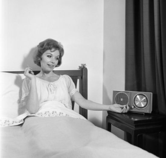 SAL255420777 Portrait of Mid Adult Woman Reclining in Bed & Listening to the Radio Poster Print - 18 x 24 in.