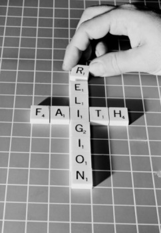 Mans Hand Making Religious Cross From Scrabble Pieces Poster Print 18 x 24 in.