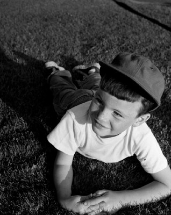 Boy Lying on Lawn Poster Print - 18 x 24 in.