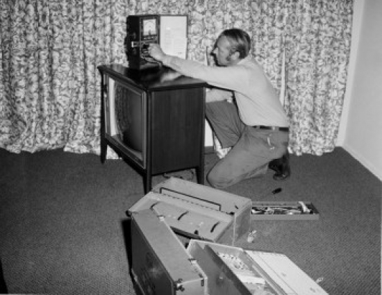 Tv Repairman at Work Poster Print - 18 x 24 in.