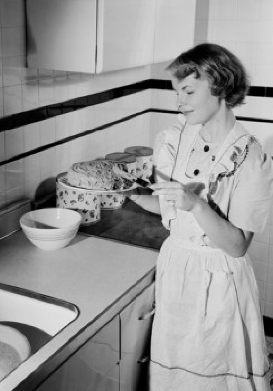 Young Woman Icing Cake in Kitchen Poster Print - 18 x 24 in.