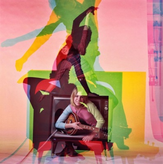 Portrait of a Young Woman Holding a Guitar & Emerging From a Television Poster Print - 18 x 24 in.