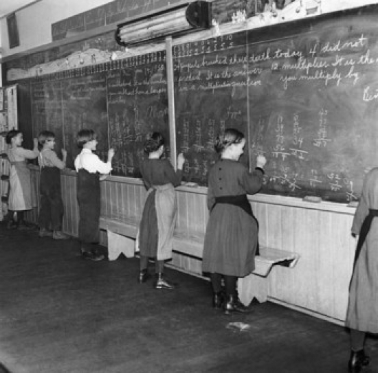 Students Solving Math Problems on a Blackboard Poster Print - 18 x 24 in.