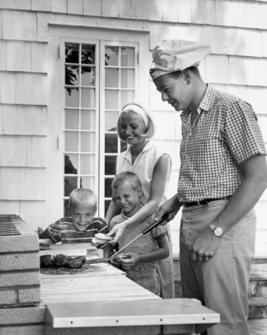 SAL2554577 Side Profile of a Mid Adult Man Cooking Food with His Wife & Two Children Standing Beside Him Poster Print - 18 x 24 in.