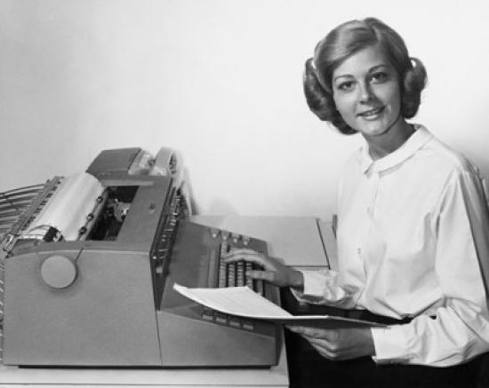 Young Woman Using a Typewriter Poster Print - 18 x 24 in.