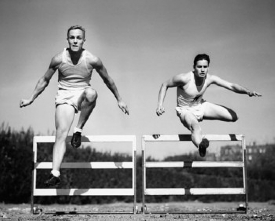 Two Athletes Jumping Over Hurdles Poster Print - 18 x 24 in.