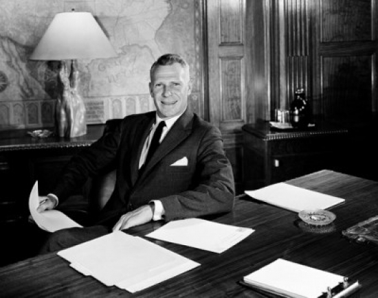 Businessman at Desk Holding Documents Poster Print - 18 x 24 in.