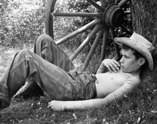 Boy Lying Near a Wagon Wheel Poster Print - 18 x 24 in.