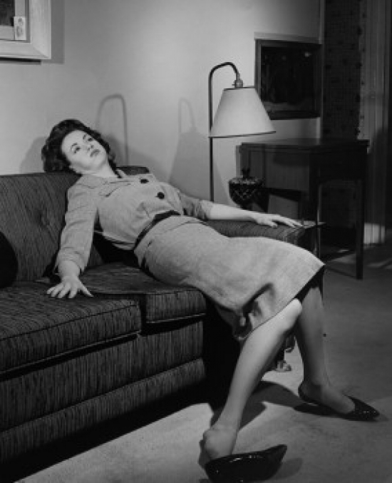 Young Woman Resting on a Couch Poster Print - 18 x 24 in.