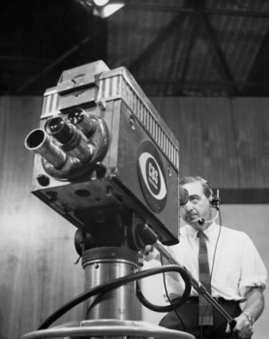 Low Angle View of a Cameraman Operating a Television Camera Poster Print - 18 x 24 in.