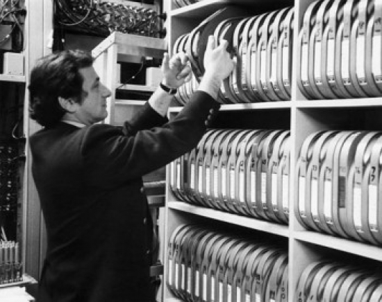 Side Profile of a Mid Adult Man Pulling Containers From a Rack Poster Print 18 x 24 in.