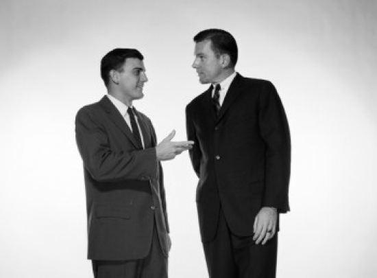 Two Businessmen Talking to Each Other Poster Print - 18 x 24 in.