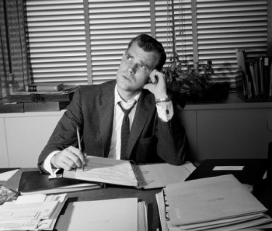 Businessman Working at Desk Poster Print - 18 x 24 in.