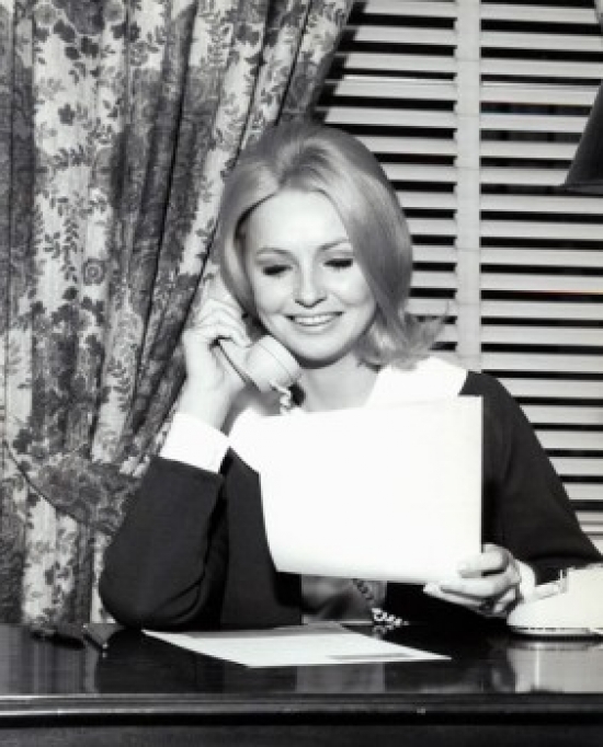 Woman Reading Document & Talking on Phone Poster Print - 18 x 24 in.