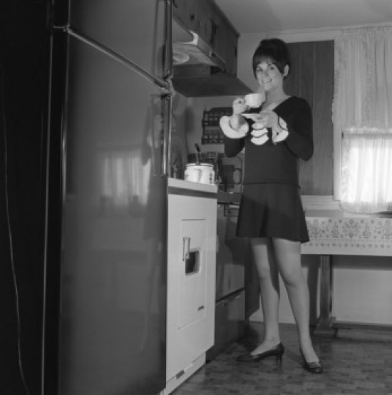 Woman Drinking Tea in Kitchen Poster Print - 18 x 24 in.