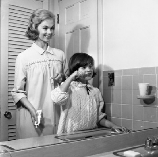 Mother Assisting Daughter with Brushing Teeth Reflecting in Mirror Poster Print - 18 x 24 in.