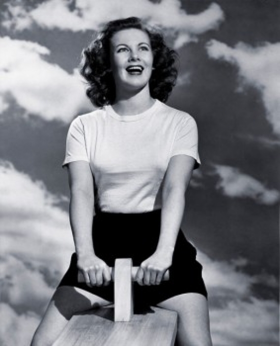 Low Angle View of a Young Woman Sitting on a Seesaw Poster Print - 18 x 24 in.