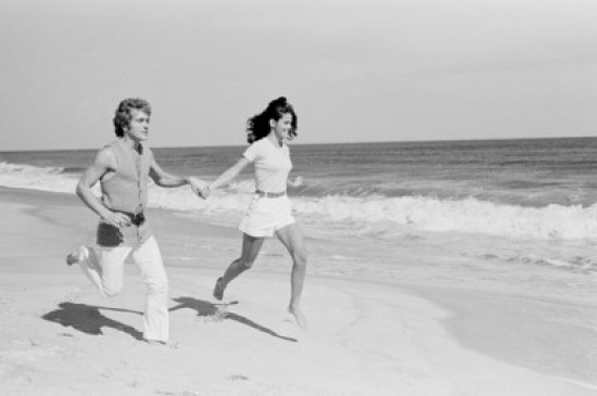 Young Couple Running Across Beach Poster Print - 18 x 24 in.